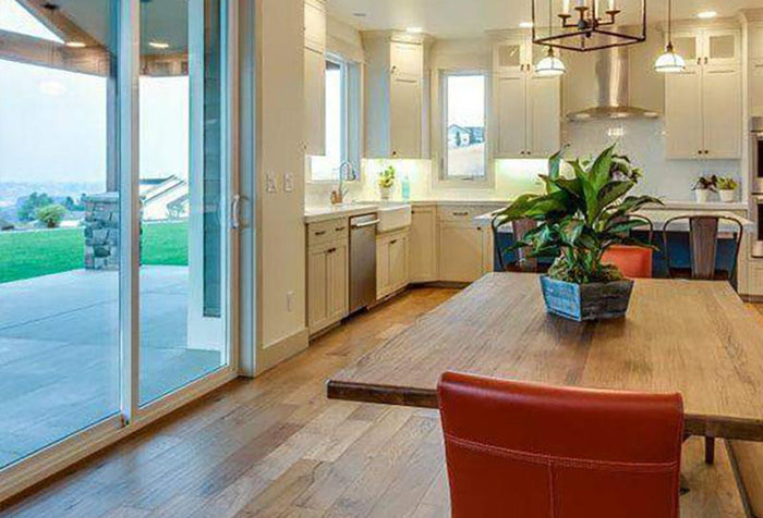 An open concept kitchen with Shaw hardwood flooring, available at Standard Paint & Flooring, serving the Yakima Valley, Washington & Oregon.