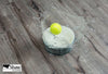 Close up of Shaw waterproof laminate flooring in Pinnacle Plus, with a tennis ball spilling a bowl of water.