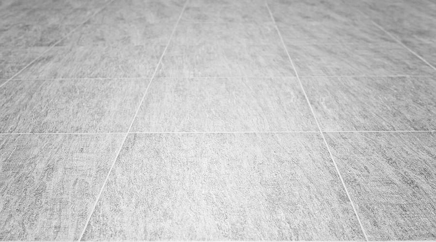 Light grey vinyl flooring tile with white grout.