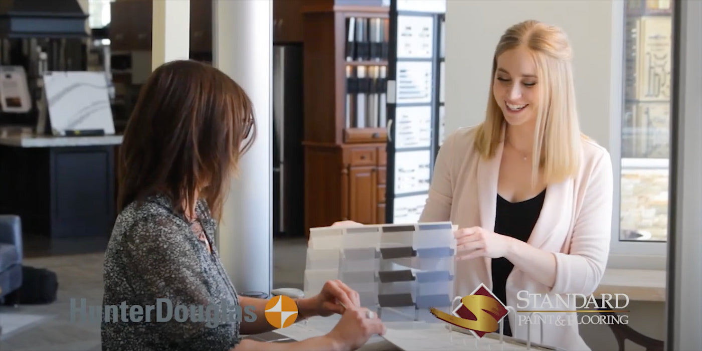Our Design Specialist Maddie helping a customer choose color and fabric for a Hunter Douglas custom blind.