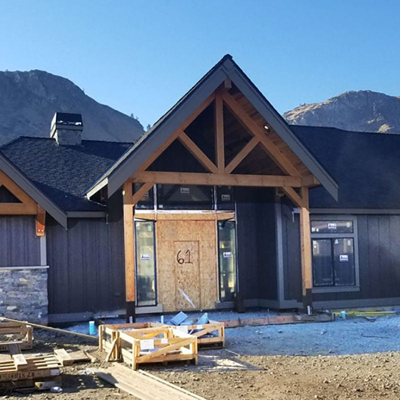 Exterior of a house being built with dark grey paint from Standard Paint & Flooring.