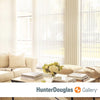 Modern vertical white Hunter Douglas window treatments in a beige or gray living room.