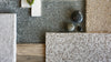 Shaw Bellera carpet swatches in light grey, dark grey, white and brown tones.