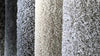Carpet swatches in dark grey, beige and light grey. 