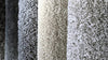 Carpet swatches in dark grey, beige and light grey. 