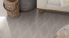 Light grey carpet with a textured curvy design throughout.