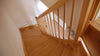 View from the top of a natural hardwood spiralled staircase.