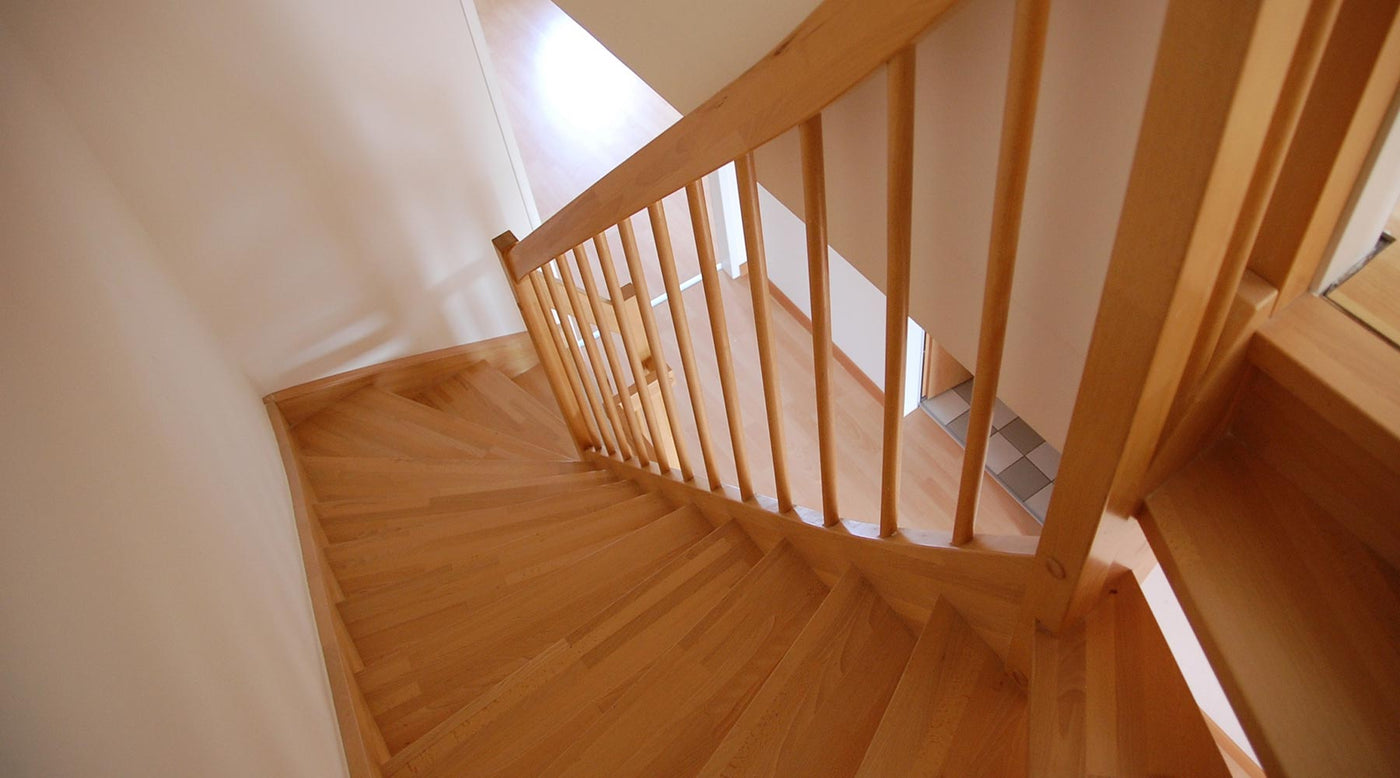 View from the top of a natural hardwood spiralled staircase.
